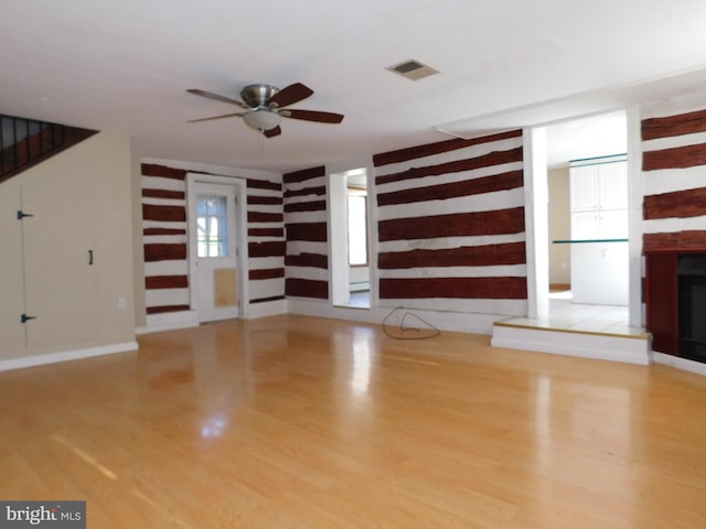 unfurnished living room featuring ceiling fan and light hardwood / wood-style flooring