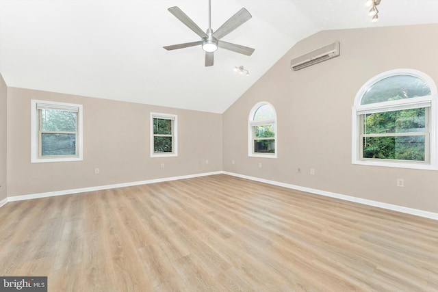 unfurnished room featuring a wall mounted AC, plenty of natural light, and light wood-type flooring