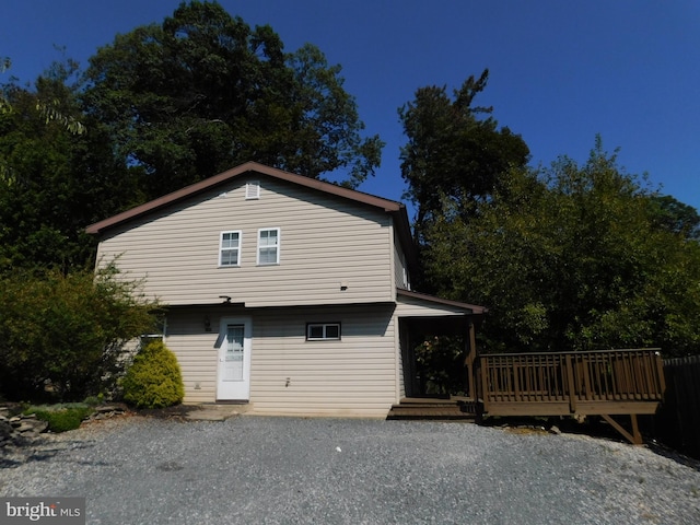 rear view of house with a wooden deck