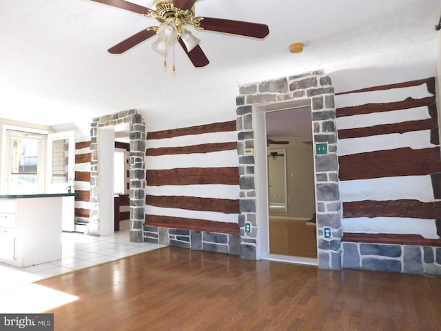 unfurnished living room with ceiling fan and hardwood / wood-style floors