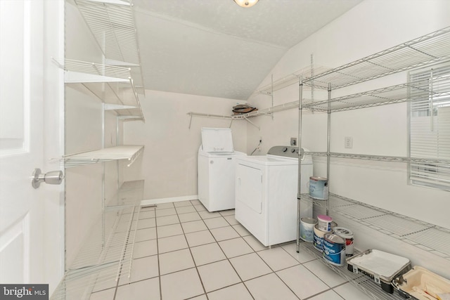 laundry area featuring light tile patterned floors and separate washer and dryer