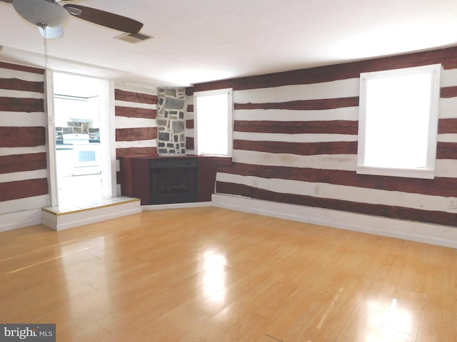 unfurnished living room featuring hardwood / wood-style flooring and ceiling fan