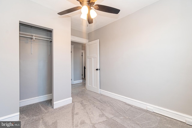 unfurnished bedroom featuring ceiling fan, a closet, and light colored carpet