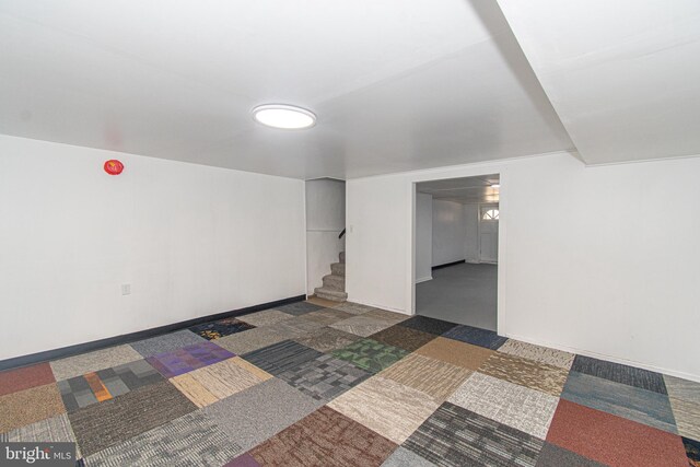 basement featuring dark carpet