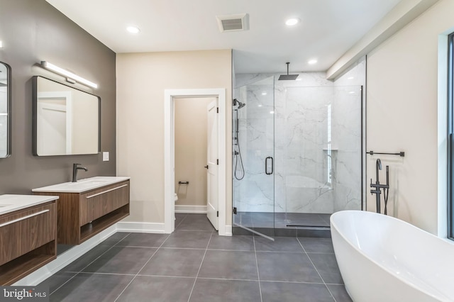 full bathroom with tile patterned floors, toilet, vanity, and shower with separate bathtub