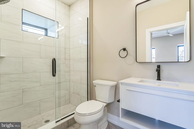 bathroom with vanity, a shower with shower door, and toilet