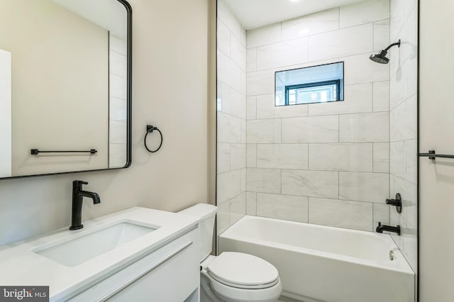 full bathroom with vanity, tiled shower / bath combo, and toilet