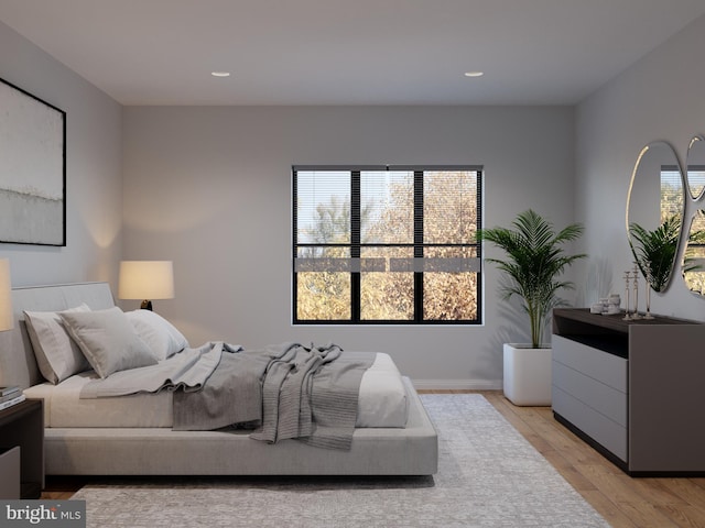 bedroom featuring light wood-type flooring and multiple windows