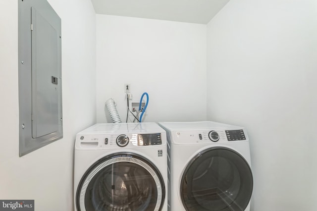 laundry area featuring electric panel and washer and dryer