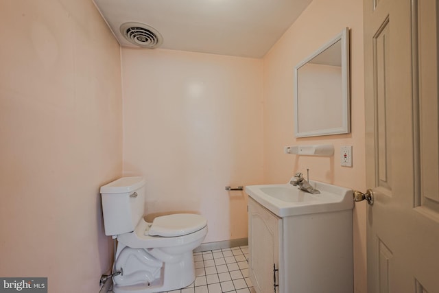 bathroom with vanity, tile patterned flooring, and toilet