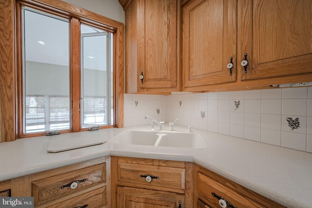 kitchen featuring sink and tasteful backsplash