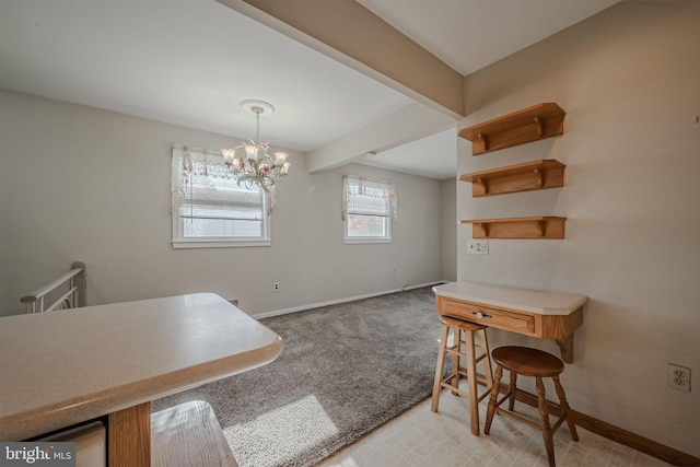 carpeted dining room with beamed ceiling and a chandelier