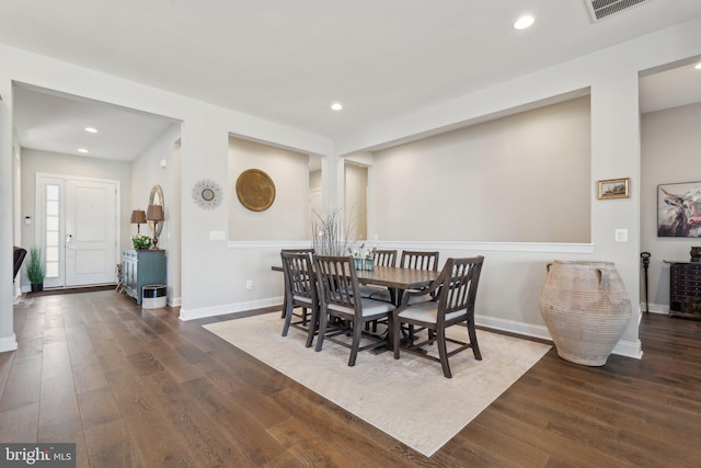 dining space with dark hardwood / wood-style floors