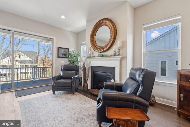 sitting room with hardwood / wood-style flooring and a healthy amount of sunlight