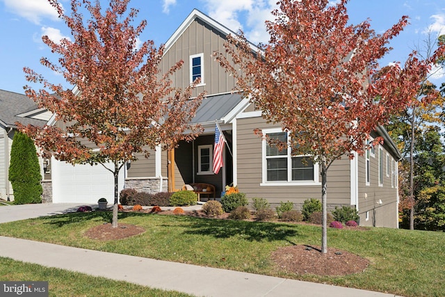 obstructed view of property with a garage and a front lawn