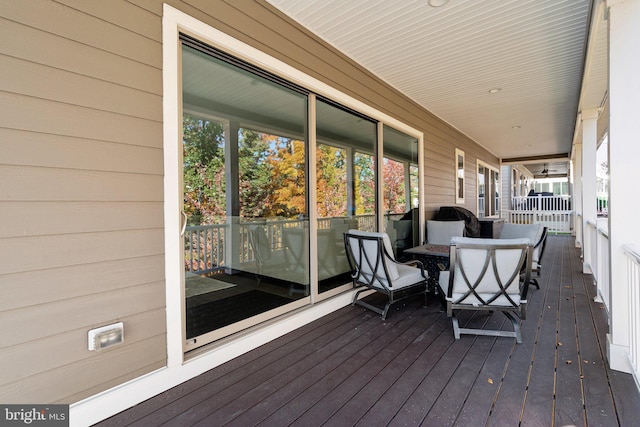 wooden terrace featuring covered porch