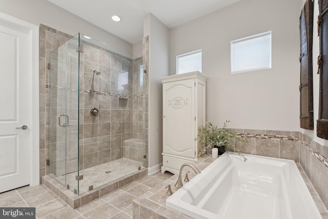 bathroom featuring tile patterned floors and separate shower and tub