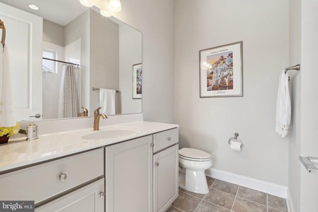 bathroom featuring tile patterned floors, vanity, toilet, and curtained shower