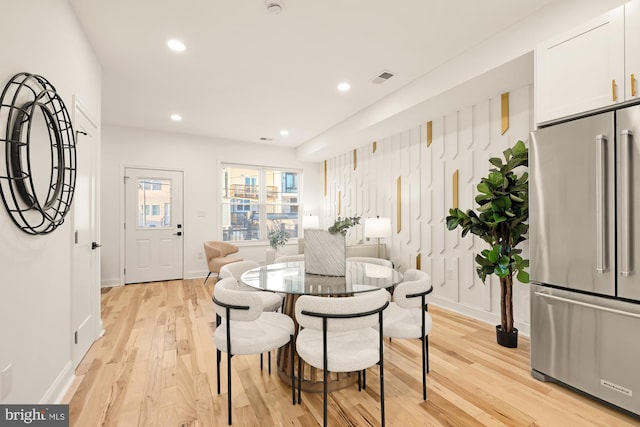 dining area featuring light wood-type flooring