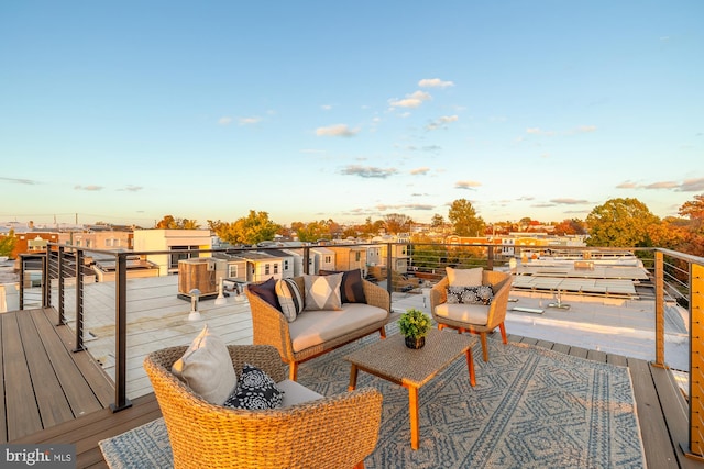 deck at dusk with outdoor lounge area