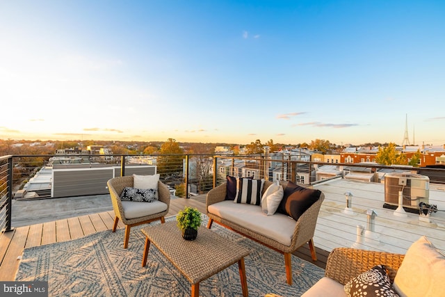 deck at dusk featuring an outdoor living space