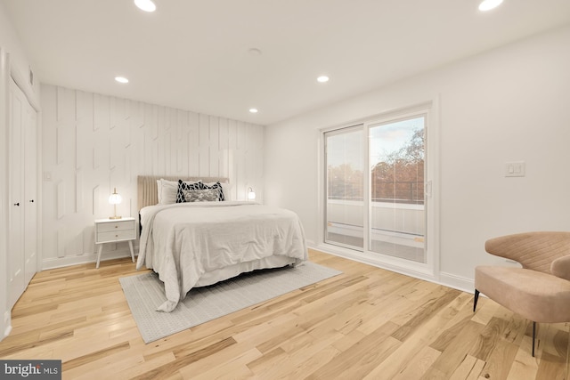 bedroom with access to outside and light hardwood / wood-style floors