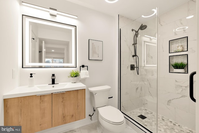 bathroom with an enclosed shower, vanity, and toilet