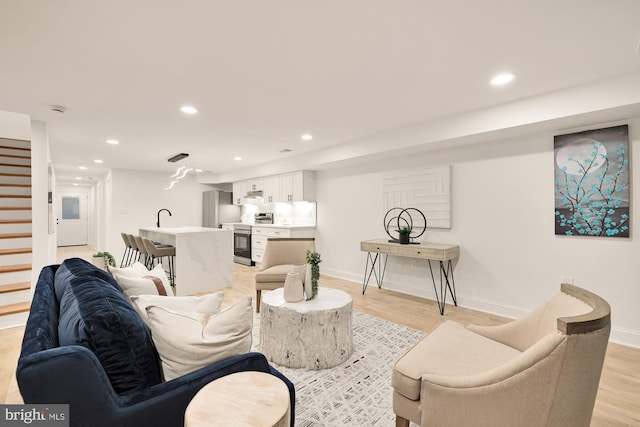 living room featuring light hardwood / wood-style floors and sink