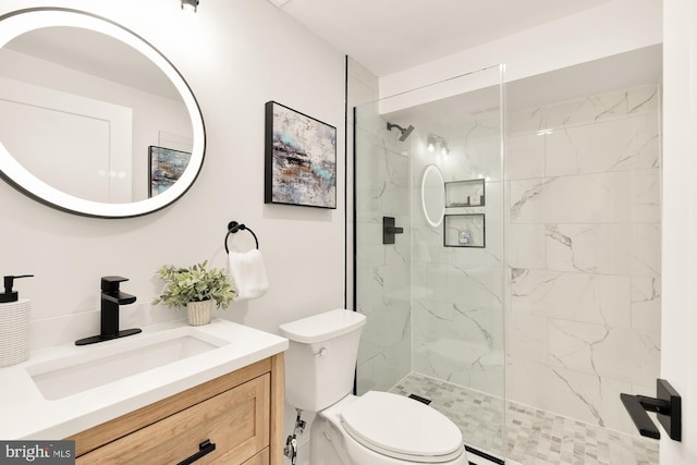 bathroom featuring a baseboard heating unit, a tile shower, vanity, and toilet