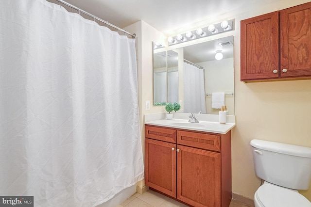 bathroom featuring vanity, curtained shower, tile patterned floors, and toilet