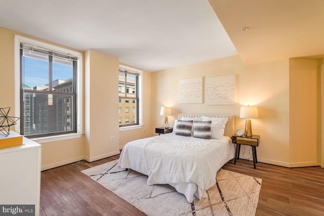 bedroom with dark hardwood / wood-style flooring