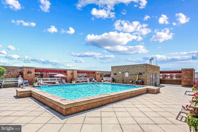 view of swimming pool with a patio area