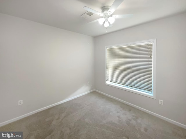 spare room with carpet and ceiling fan