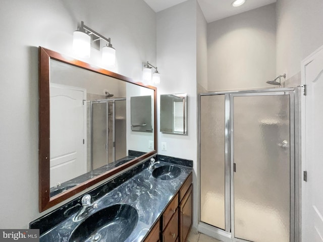 bathroom with walk in shower and vanity