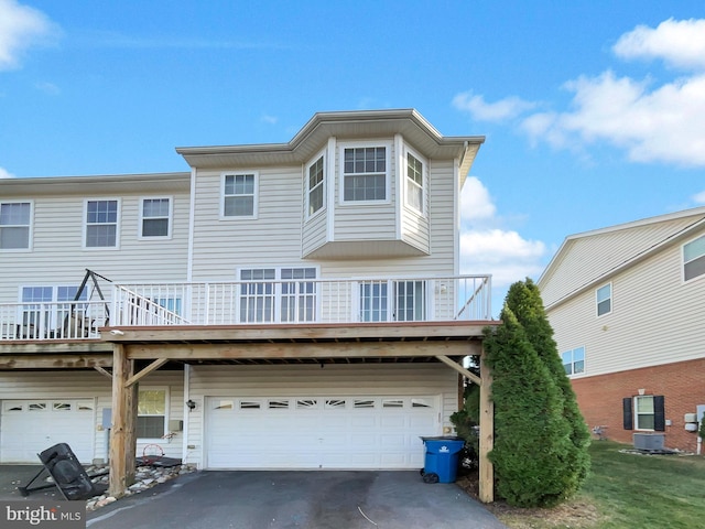 view of front of home with a deck and a garage