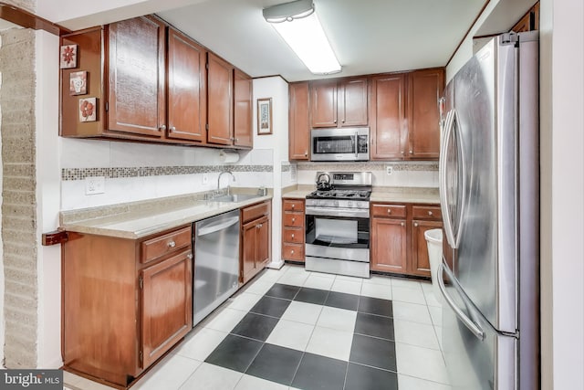 kitchen featuring stainless steel appliances, sink, tasteful backsplash, and light tile patterned floors