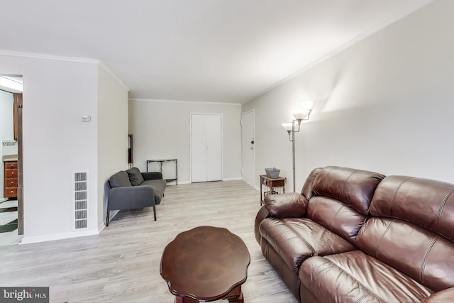 living room with light hardwood / wood-style floors and crown molding