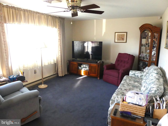 living room with ceiling fan, dark carpet, and a baseboard radiator