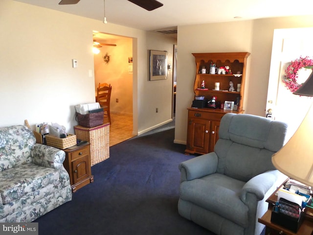 living room with ceiling fan and dark carpet