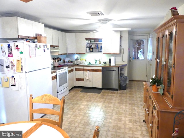 kitchen with white cabinets, sink, white appliances, and ceiling fan