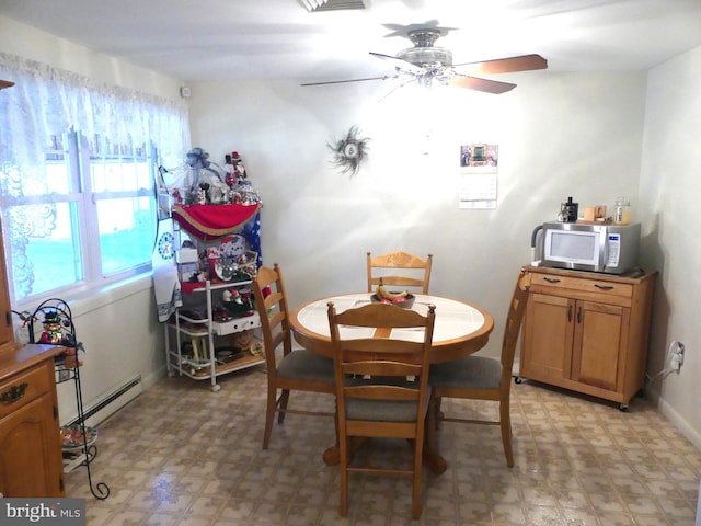 dining room featuring a baseboard heating unit and ceiling fan