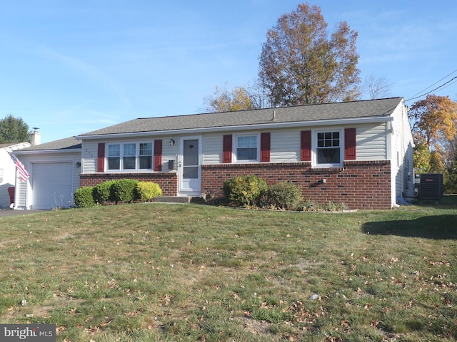 ranch-style house featuring a garage, a front lawn, and central AC