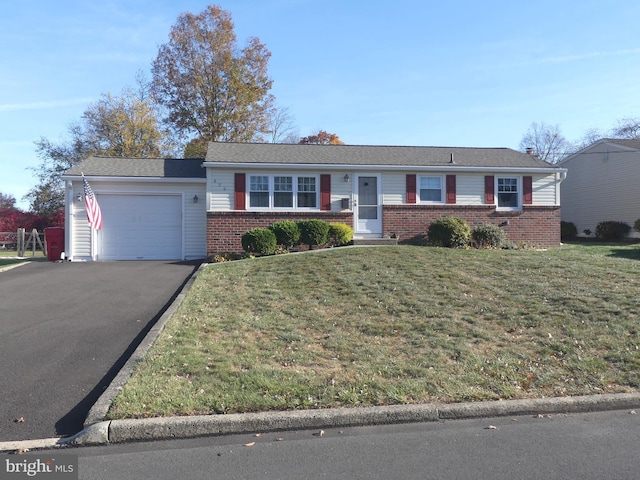 ranch-style home with a garage and a front lawn