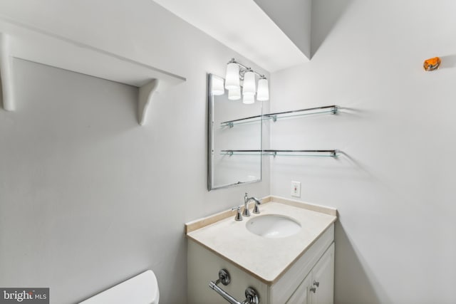 bathroom featuring vanity and toilet