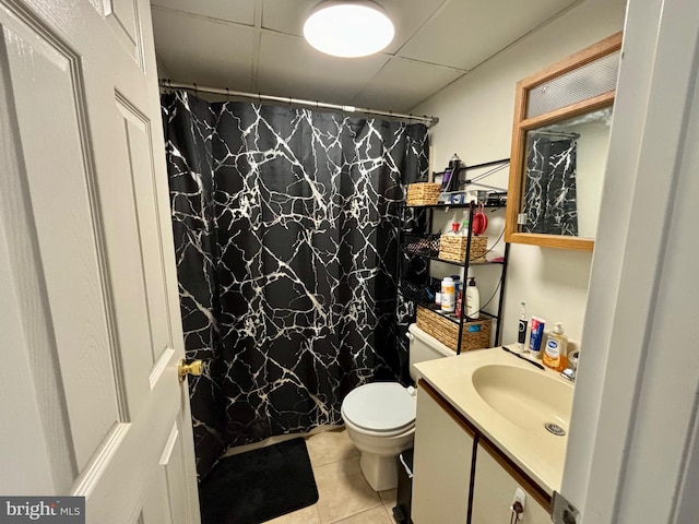 bathroom with toilet, curtained shower, vanity, and tile patterned floors