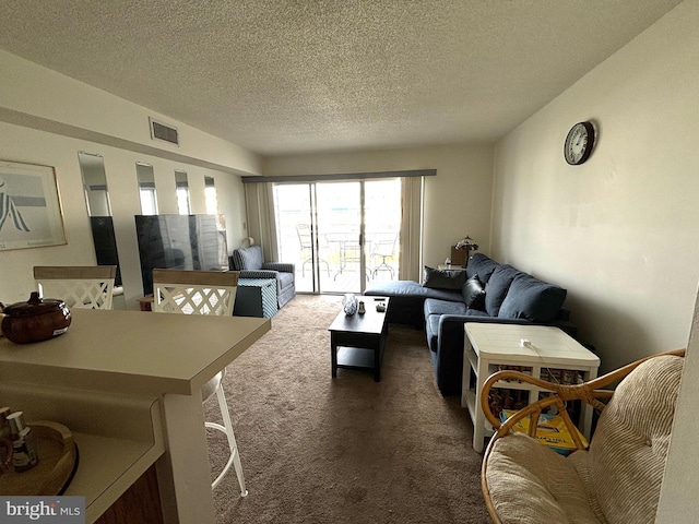 carpeted living area featuring a textured ceiling and visible vents