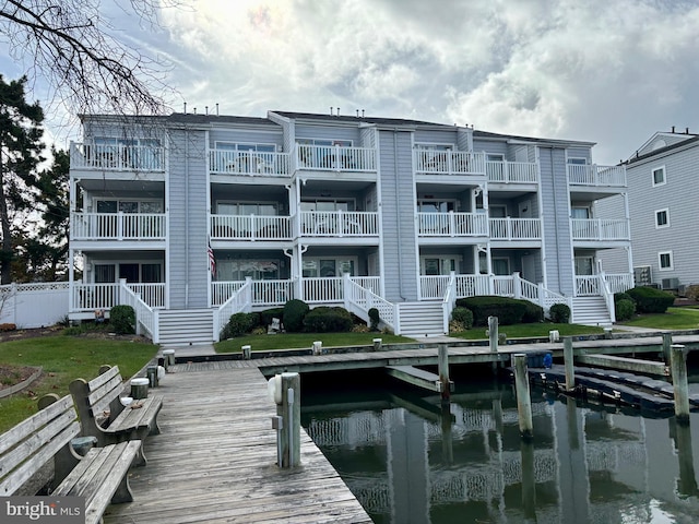 dock area with stairway and a water view