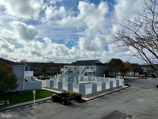 view of front facade featuring a residential view and uncovered parking