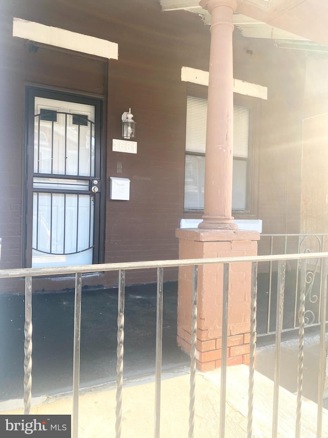 view of exterior entry featuring ceiling fan