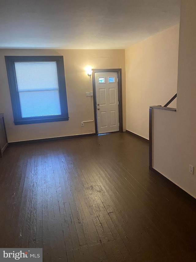 entryway with dark wood-type flooring